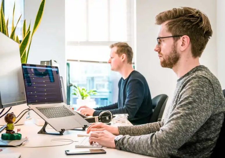 Website builder in front of a computer